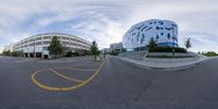 a 360 - turn photo taken with fish - eye lens camera of an intersection in front of the hospital