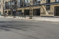 an empty street with signs along the side of the building on one side and buildings on the other