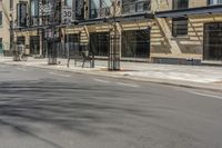 an empty street with signs along the side of the building on one side and buildings on the other