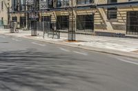 an empty street with signs along the side of the building on one side and buildings on the other