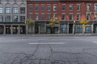 an empty city street with the buildings and signs showing signs for businesses that are closed