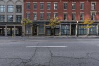 an empty city street with the buildings and signs showing signs for businesses that are closed