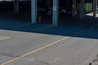 an empty parking lot with yellow signs and yellow cones on the pavement and yellow markings in the parking spaces