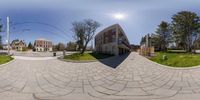 360 - view of a circular image of a driveway in front of a house, trees and sky