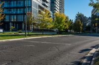 a fire hydrant standing on the street next to tall buildings with windows and trees