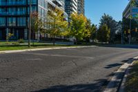 a fire hydrant standing on the street next to tall buildings with windows and trees