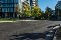 a fire hydrant standing on the street next to tall buildings with windows and trees