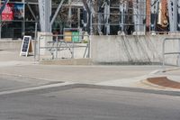 a person on a skateboard doing a trick in the air over a ramp in front of a building