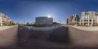 a panoramic photo with buildings and traffic lights on a sunny day in an urban setting