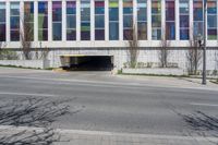 a parking garage has been opened on the corner of the road to let pedestrians into