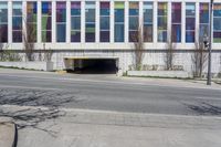 a parking garage has been opened on the corner of the road to let pedestrians into