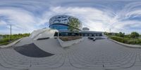 a circular view of a building with a skateboarder riding it on the ramp