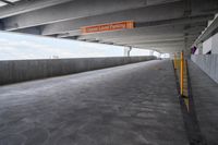 a walkway is empty with a sign in the middle of it that reads upper level parking