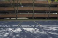 parking garage with three trees in front of it and a fire hydrant on the ground