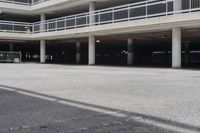 a parking garage full of vehicles with balconies on the balcony above it's balcony