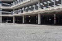 a parking garage full of vehicles with balconies on the balcony above it's balcony