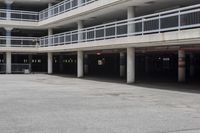 a parking garage full of vehicles with balconies on the balcony above it's balcony