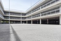 empty parking garages with buildings on both sides of each of them, and several walkways in the middle