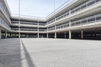 empty parking garages with buildings on both sides of each of them, and several walkways in the middle