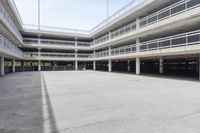 empty parking garages with buildings on both sides of each of them, and several walkways in the middle