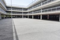 empty parking garages with buildings on both sides of each of them, and several walkways in the middle