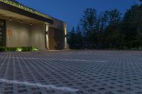 a large parking lot has a checkered pattern of concrete and stone tiles on it