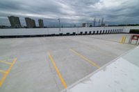 view from the bottom of an airplane over an empty parking lot with lots of windows