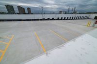 view from the bottom of an airplane over an empty parking lot with lots of windows