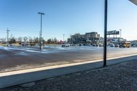 a parking lot in the afternoon sun with some cars and buses parked in the lot