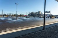 a parking lot in the afternoon sun with some cars and buses parked in the lot