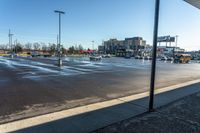 a parking lot in the afternoon sun with some cars and buses parked in the lot