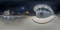 a view of a parking lot from a fish eye lens at night in an urban city