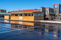 a big parking lot with several buildings and a few signs that say burgers on the building