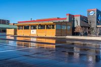 a big parking lot with several buildings and a few signs that say burgers on the building