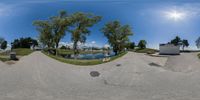 the view is very good in this 3d fish eye lens shot of a pond on a hill