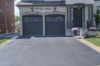 a large driveway with a couple of windows on it and a sign that says, house entrance