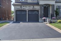 a large driveway with a couple of windows on it and a sign that says, house entrance