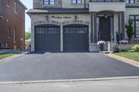 a large driveway with a couple of windows on it and a sign that says, house entrance