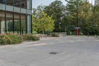 a walkway with plants, trees and a fire hydrant in front of the building