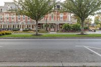 street view of the beautiful home in a city park area with trees on either side