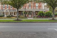 street view of the beautiful home in a city park area with trees on either side