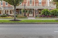 street view of the beautiful home in a city park area with trees on either side