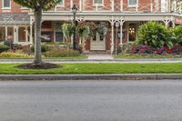 street view of the beautiful home in a city park area with trees on either side