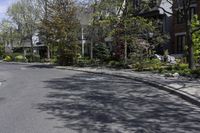 this is an image of residential houses lining the street in front of a car parks on the sidewalk