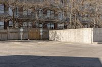 a street and fence in the background with the words no parking on it and a car parked by