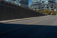 a sidewalk with two buildings on the other side of it that is empty and not in use