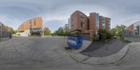 this is the 360 - 360 image of a school that has several buildings and blue bins