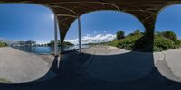 an image of two fisheyes looking at the bridge from under them and one view of water