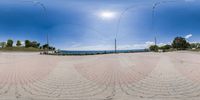 there is a view of a street and an ocean from inside it, taken from a fish eye view point on the goproud