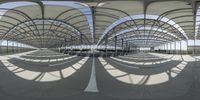 an outdoor area in the shape of a circle, with some shade, outside a train station